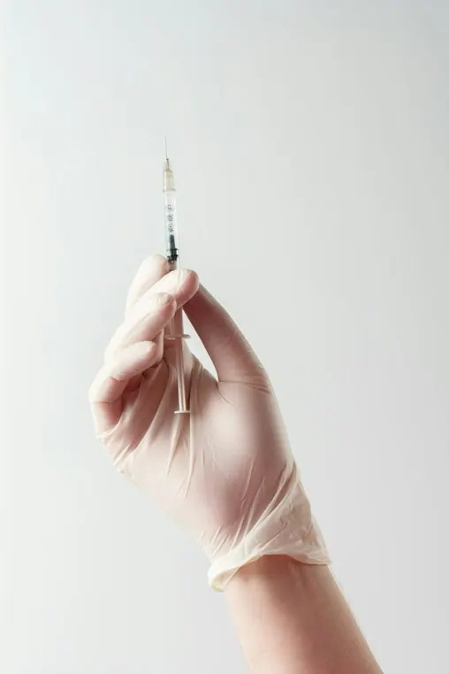 A hand holding a fine needle