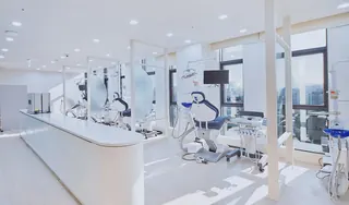 Open treatment area with dental chairs along the windows