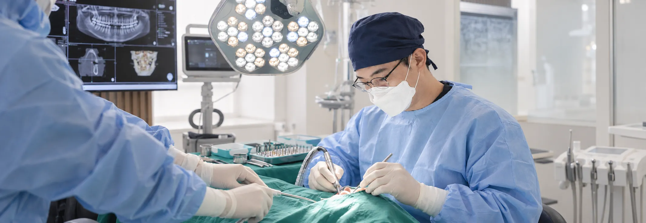 Medical staff treating a sedated patient in the operating room